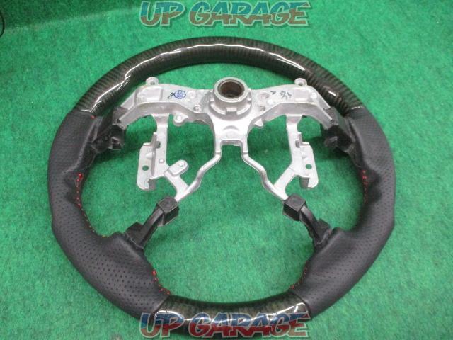 Unknown Manufacturer
Gun grip steering
Punching leather x black carbon
Number: 45103-12590-06